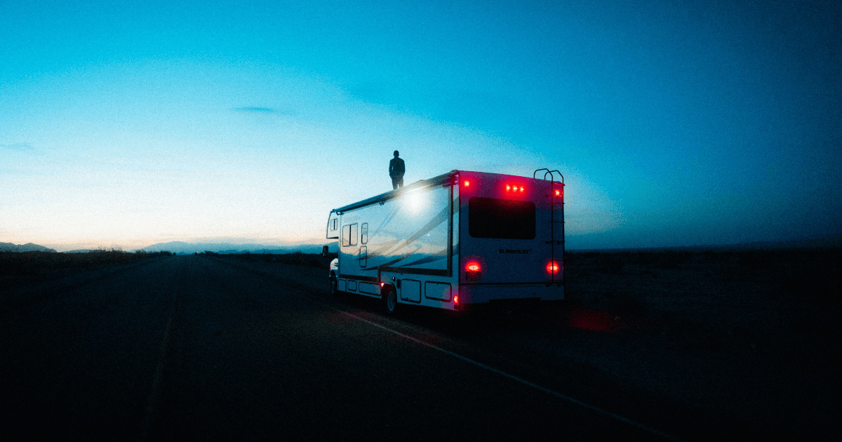 An RV owner checking the oil on a built-in Onan generator through the access panel